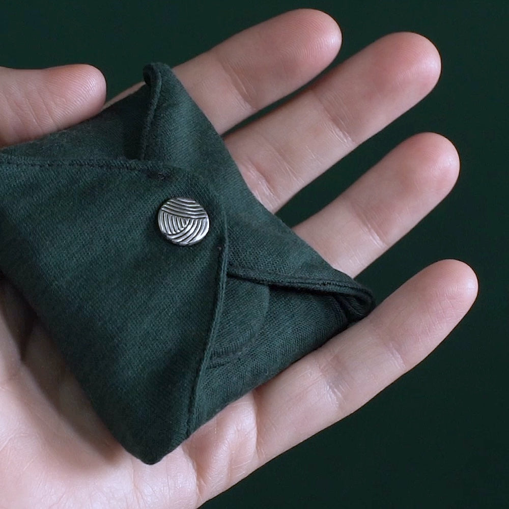 DAME Reusable Period Pad folded in hand